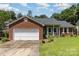 Charming brick home with a well-maintained lawn and attached garage at 9520 Marshbrooke Rd, Matthews, NC 28105