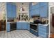 Cozy kitchen featuring blue cabinets, white countertops, and a decorative backsplash at 9520 Marshbrooke Rd, Matthews, NC 28105