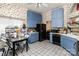 Quaint kitchen with blue cabinets, white tile floors, and fruit themed wallpaper at 9520 Marshbrooke Rd, Matthews, NC 28105