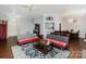 Cozy living area with hardwood floors, ceiling fan, and ample natural light at 9520 Marshbrooke Rd, Matthews, NC 28105