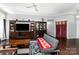 Bright living area featuring hardwood floors, a ceiling fan, and elegant display cabinets at 9520 Marshbrooke Rd, Matthews, NC 28105