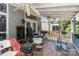 Outdoor porch with ceiling fans, chairs, and cooking equipment at 9520 Marshbrooke Rd, Matthews, NC 28105