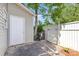 Private backyard with a white door to the garage, fenced in area, and mature trees at 9664 Littleleaf Dr, Charlotte, NC 28215
