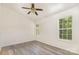 Bright bedroom with ceiling fan, new laminate flooring, and fresh paint at 9664 Littleleaf Dr, Charlotte, NC 28215