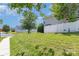 Well-maintained front lawn with lush green grass and a sidewalk leading to the street at 9664 Littleleaf Dr, Charlotte, NC 28215