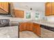 Efficient kitchen with stone countertops, updated appliances, and natural wood cabinetry at 9664 Littleleaf Dr, Charlotte, NC 28215