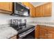 Close-up of the kitchen with stainless steel appliances and stone countertops at 9664 Littleleaf Dr, Charlotte, NC 28215