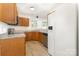 Bright kitchen features wood cabinets, modern appliances, and a large refrigerator at 9664 Littleleaf Dr, Charlotte, NC 28215