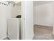 Bright laundry room features a modern washing machine and convenient built-in shelving at 9664 Littleleaf Dr, Charlotte, NC 28215