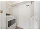 Small laundry room with a washer and dryer and white shelving at 9664 Littleleaf Dr, Charlotte, NC 28215