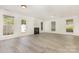 Bright and open living room featuring a fireplace, ceiling fan, and fresh paint at 9664 Littleleaf Dr, Charlotte, NC 28215