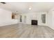 Spacious living room area with fireplace, ceiling fan, and views of the kitchen at 9664 Littleleaf Dr, Charlotte, NC 28215