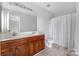 Bathroom features double sink vanity, framed mirror, shower with patterned curtain at 9728 Blossom Hill Dr, Huntersville, NC 28078
