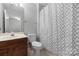 Bathroom features sink vanity, framed mirror, toilet, and patterned shower curtain at 9728 Blossom Hill Dr, Huntersville, NC 28078