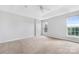 Bright bedroom features tray ceiling, plush carpet and large windows at 9728 Blossom Hill Dr, Huntersville, NC 28078
