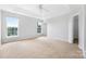 Bright bedroom features tray ceiling, plush carpet and large windows at 9728 Blossom Hill Dr, Huntersville, NC 28078
