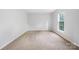 Bright bedroom features plush carpet and a window at 9728 Blossom Hill Dr, Huntersville, NC 28078