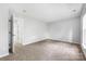 Bright bedroom features plush carpet, neutral paint and a door at 9728 Blossom Hill Dr, Huntersville, NC 28078