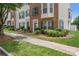 Charming townhome with brick facade, green shutters, and beautifully landscaped front yard at 9728 Blossom Hill Dr, Huntersville, NC 28078