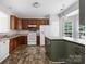 Spacious kitchen features wood cabinetry, a kitchen island, and views to the outdoors at 9728 Blossom Hill Dr, Huntersville, NC 28078