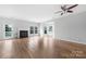 Spacious living room with fireplace and view of the outdoor balcony space at 9728 Blossom Hill Dr, Huntersville, NC 28078