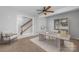 Inviting home office with neutral decor, ceiling fan, and view of the staircase at 9728 Blossom Hill Dr, Huntersville, NC 28078