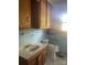 Bathroom featuring blue tiles, vintage cabinets, a toilet, and a sink at 10010 Stokes Ferry Rd, Gold Hill, NC 28071