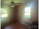 A bedroom with two windows, a ceiling fan, and light pink walls at 10010 Stokes Ferry Rd, Gold Hill, NC 28071