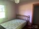 Cozy bedroom with a comfortable bed, a window, and simple decor at 10010 Stokes Ferry Rd, Gold Hill, NC 28071