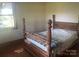 Comfortable bedroom with a vintage wooden bed frame and natural light at 10010 Stokes Ferry Rd, Gold Hill, NC 28071