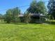 Quaint brick home surrounded by mature trees and a sprawling green yard at 10010 Stokes Ferry Rd, Gold Hill, NC 28071