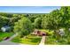 Aerial shot of the house situated on a tree-lined street, complemented by a spacious yard and charming neighborhood at 103 Little Forest Ln, Statesville, NC 28625