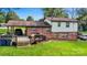 Rear view of the home showcasing a large deck, providing an ideal setting for outdoor relaxation and entertaining at 103 Little Forest Ln, Statesville, NC 28625
