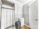 A bright bathroom featuring tile floors, a shower with curtain, storage, and neutral paint at 103 Little Forest Ln, Statesville, NC 28625