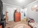 A charming bedroom with a giraffe, a small bed, carpeted floors, and natural light exudes playfulness and comfort at 103 Little Forest Ln, Statesville, NC 28625