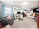 Bright bedroom featuring carpeted floors, a beanbag, shelves, a television, and natural lighting at 103 Little Forest Ln, Statesville, NC 28625