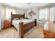 A cozy bedroom with a large bed, carpeted floors, natural light, and personal touches creates a welcoming space at 103 Little Forest Ln, Statesville, NC 28625