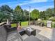 Wooden deck featuring comfortable outdoor seating, a grill, and views of the expansive, green backyard at 103 Little Forest Ln, Statesville, NC 28625