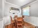 Cozy dining area with wood table, wainscoting, and natural light, ideal for Gathering meals at 103 Little Forest Ln, Statesville, NC 28625