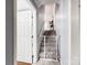 Bright hallway featuring stairs, a safety gate, carpeted floors, and freshly painted walls at 103 Little Forest Ln, Statesville, NC 28625