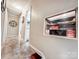 Well-lit hallway with carpeted floor, displaying decor and leading to other rooms in the home at 103 Little Forest Ln, Statesville, NC 28625