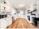 Well-lit kitchen with white cabinetry, wood floors, and modern appliances, creating a functional space at 103 Little Forest Ln, Statesville, NC 28625