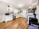 Functional kitchen with white cabinets, wood floors, and updated appliances, offering both style and convenience at 103 Little Forest Ln, Statesville, NC 28625