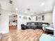 Spacious living room featuring wood floors, a comfortable gray sectional, and plenty of natural light at 103 Little Forest Ln, Statesville, NC 28625