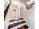 Hallway showing staircase with dark wood treads and white risers leading to upper level at 103 Little Forest Ln, Statesville, NC 28625
