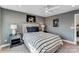 This bedroom offers neutral walls, a striped bedspread, and bedside tables with lamps at 111 Summerhill Dr # 2, Mooresville, NC 28115