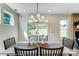 Bright dining room with modern chandelier, table setting, and sliding glass doors leading to outdoor space at 111 Summerhill Dr # 2, Mooresville, NC 28115