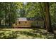 Exterior view of the home and backyard featuring a spacious deck and lush greenery at 1118 Brookwood Dr, Stanley, NC 28164