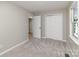 Bedroom features a closet, access to another room, and a window for natural light at 1118 Brookwood Dr, Stanley, NC 28164