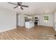 Open-concept with stainless appliances, modern pendant lighting, and natural wood flooring at 1118 Brookwood Dr, Stanley, NC 28164
